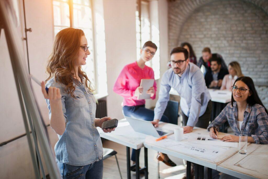 Woman giving a presentation in front of coworkers