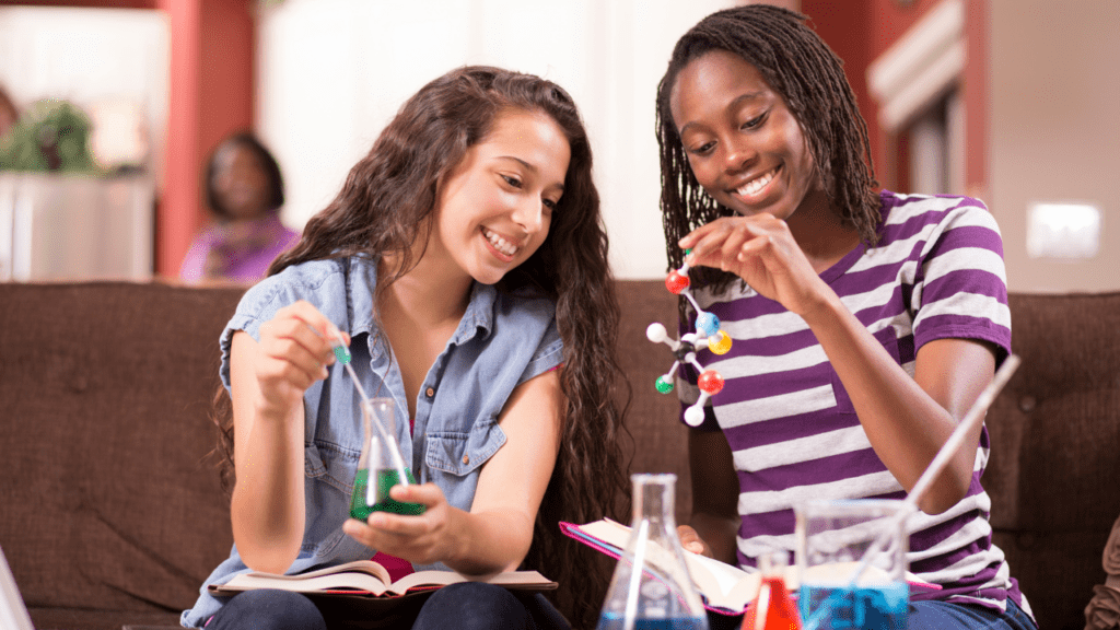 Teenage girls working on science homework