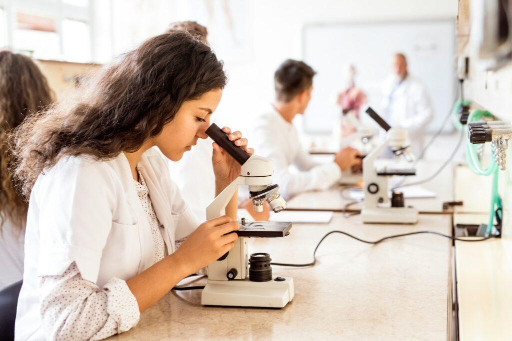 Youth looking through a microscope